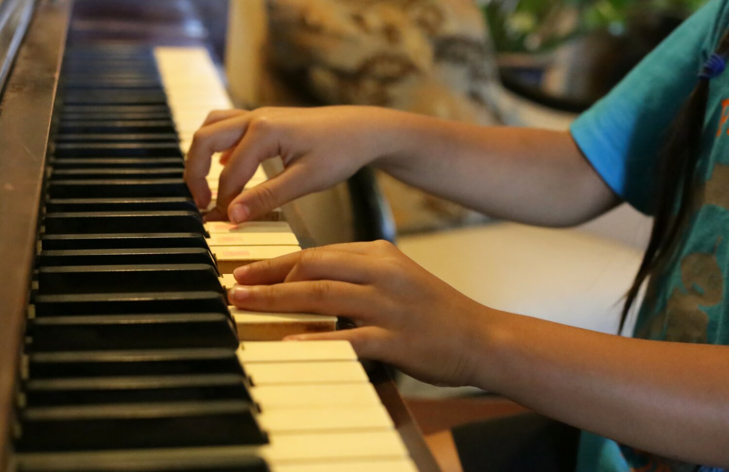 A young student plays a D minor chord.